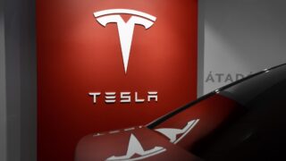 Автомобиль на фоне логотипа Tesla